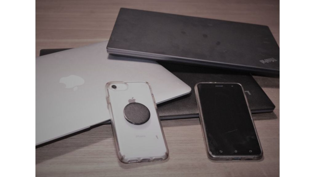 Multiple Phones Computers laying on table