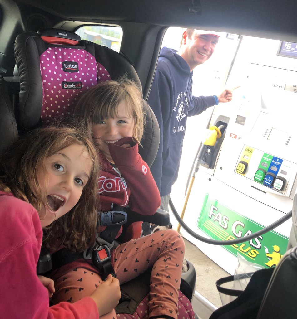 Family cheering at gas pump