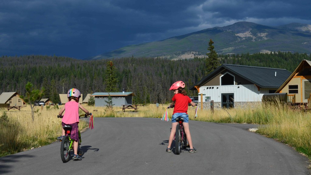 Two girls riding bikes around Whistlers Campground
