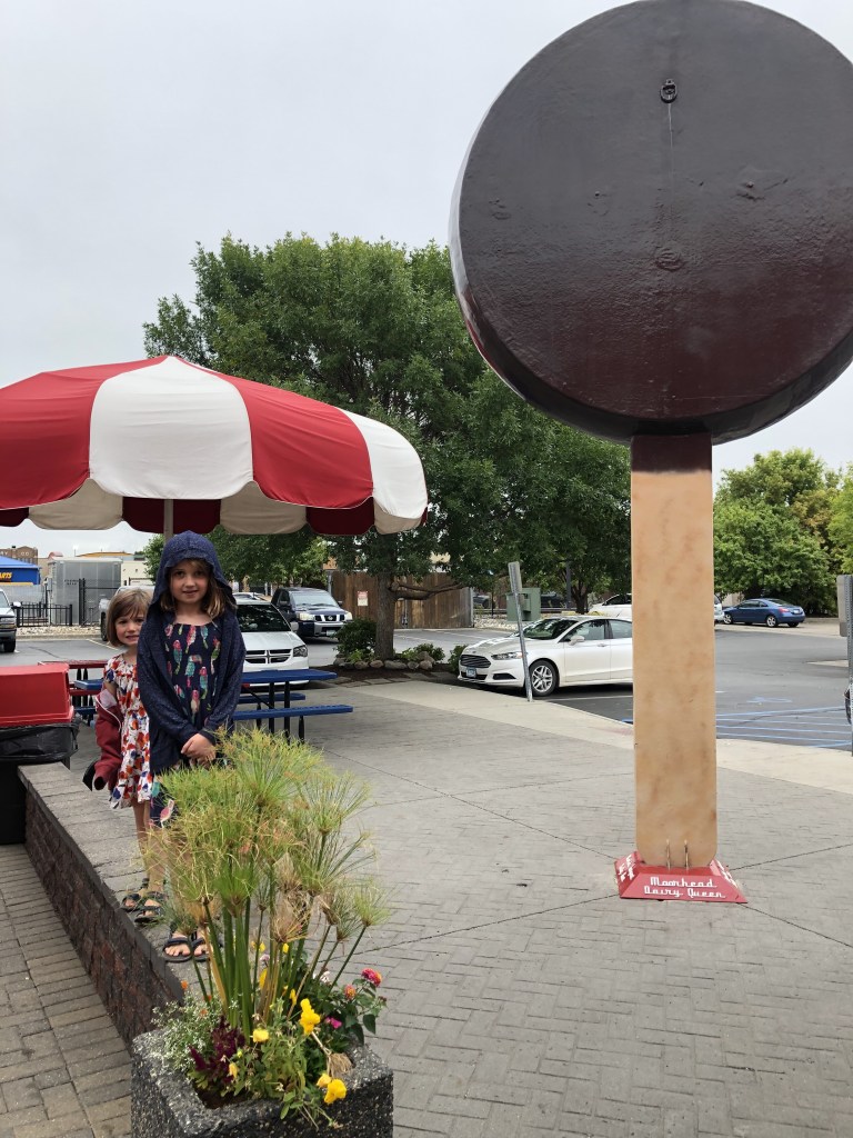 Children in front of a giant ice cream on a stick