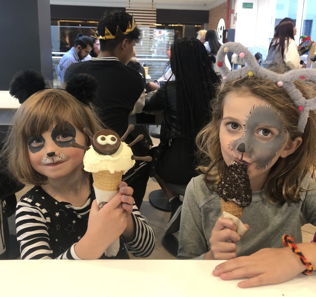 Children with halloween face paint eating ice cream