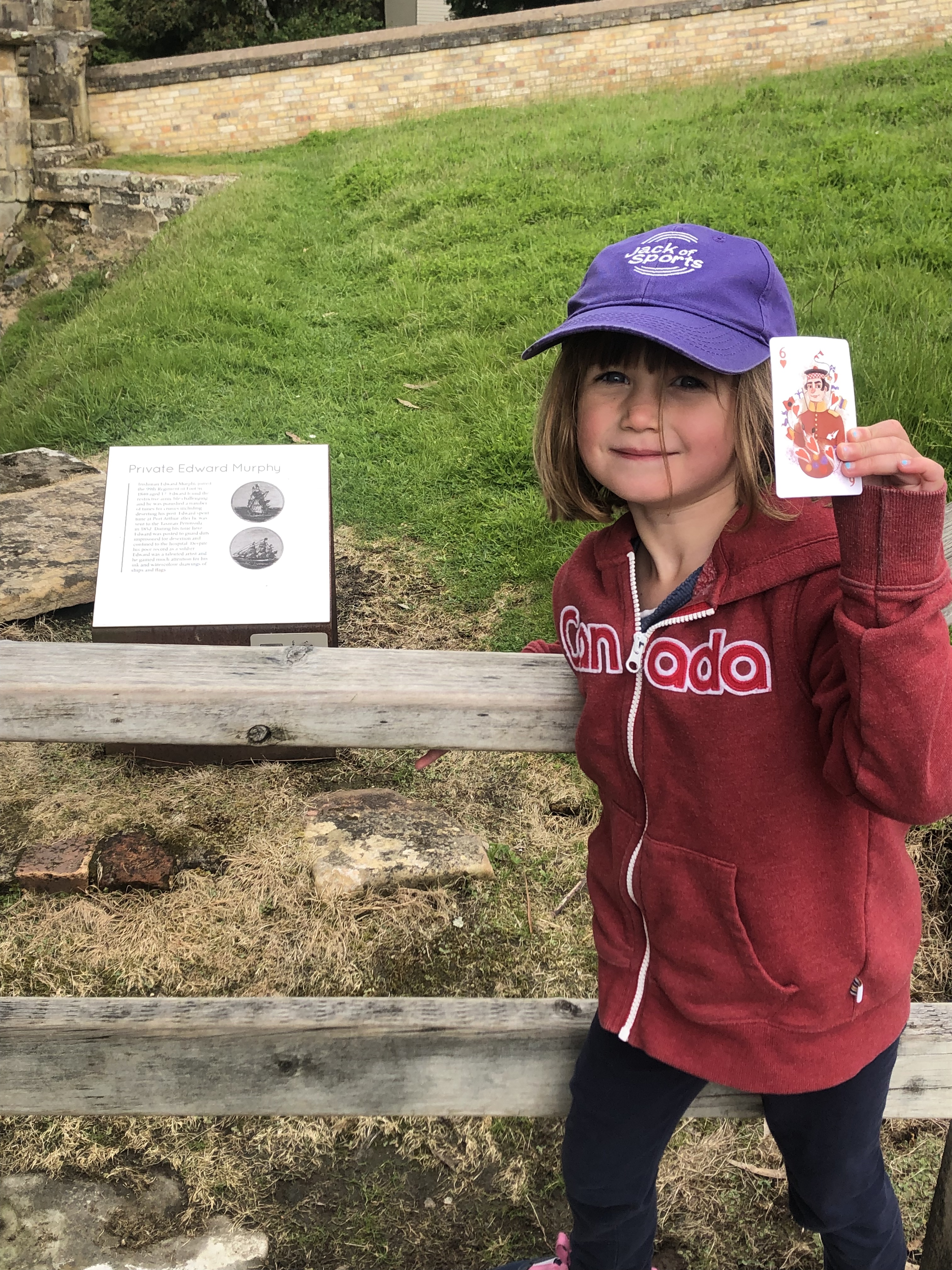 Child smiling with placard at Port Arthur