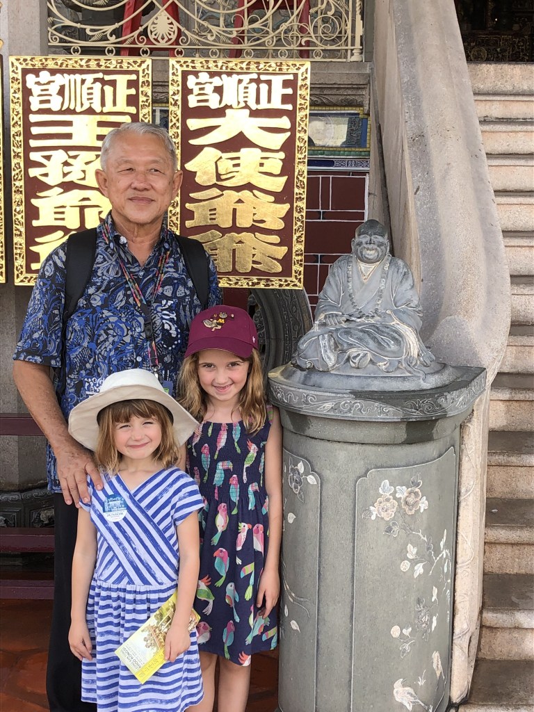 Children and tour guide at a temple entrance