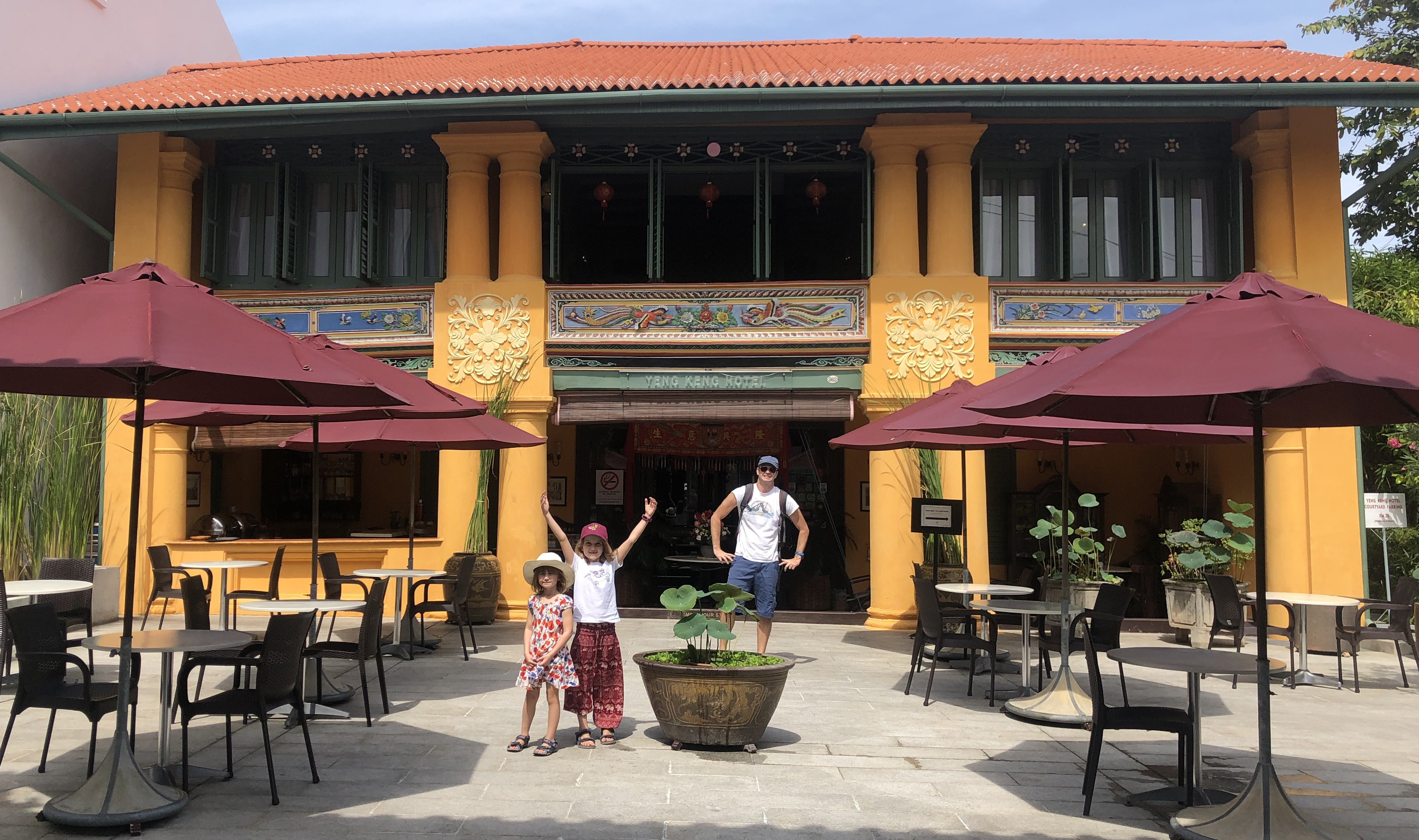 Family with children standing in front of historic hotel in Georgetown