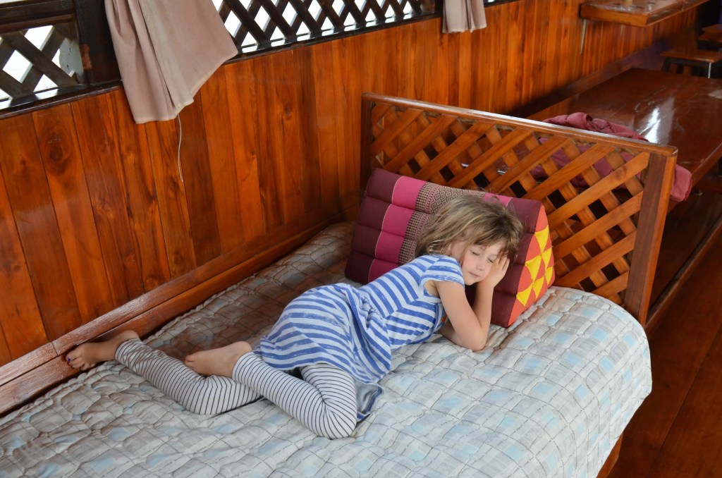 Child sleeping on coloured pillow