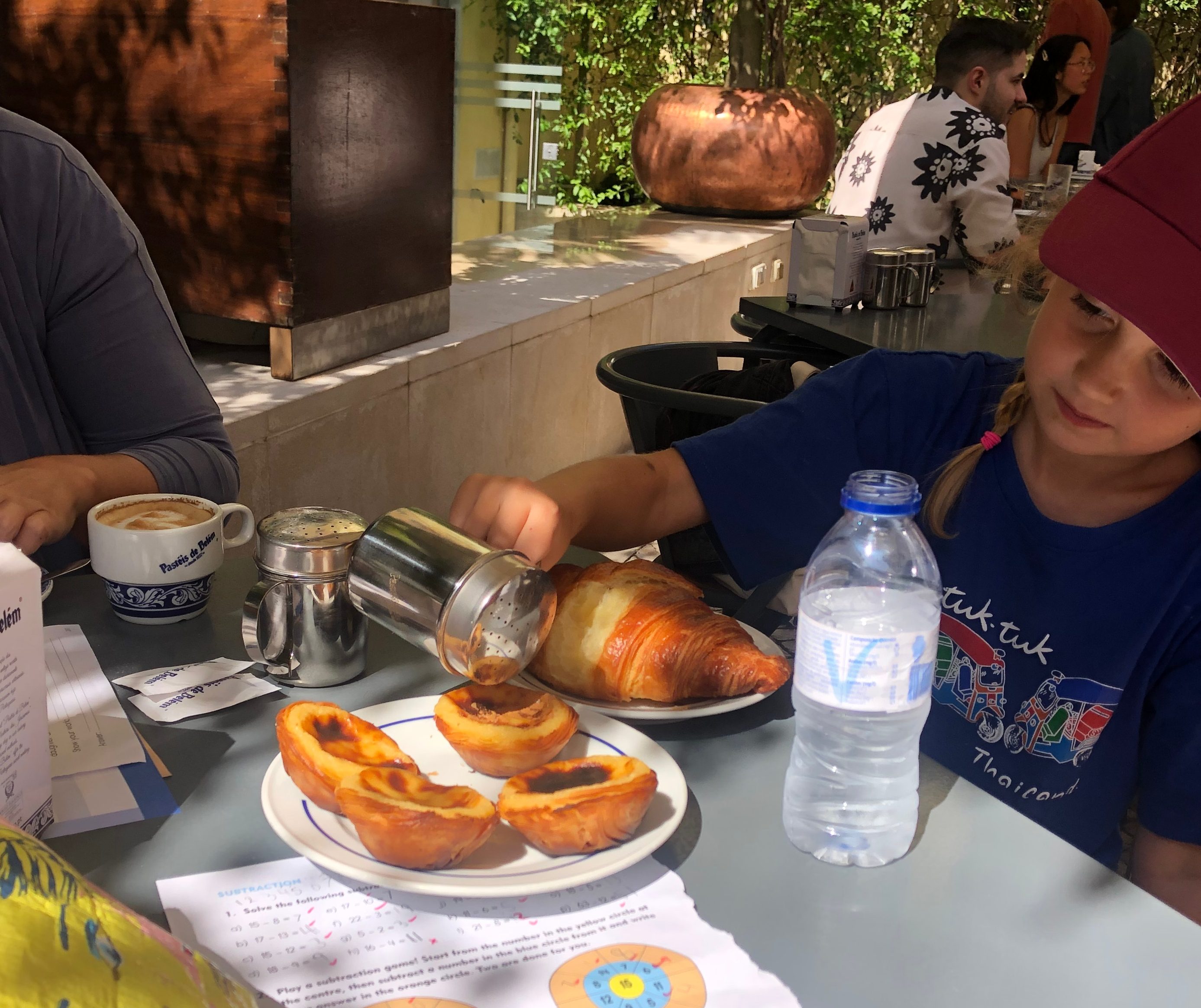 Young Girl eating Portugese custard Tarts with Cinnamon
