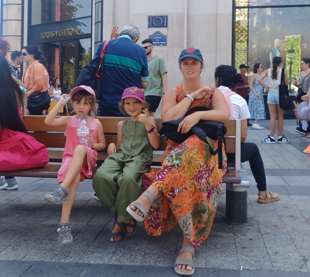 Family sitting on bench in the heat