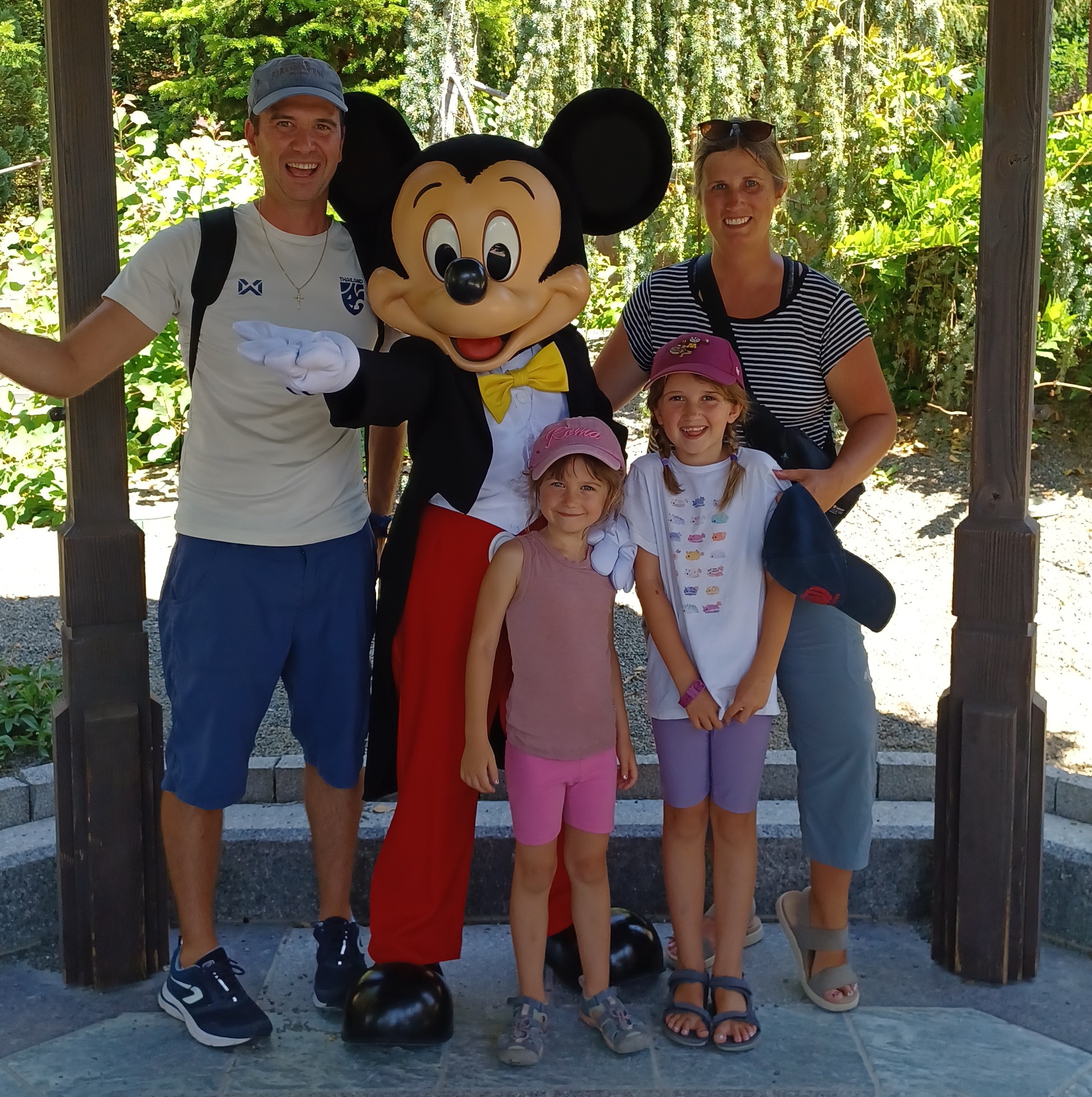 Family smiling with Mickey mouse