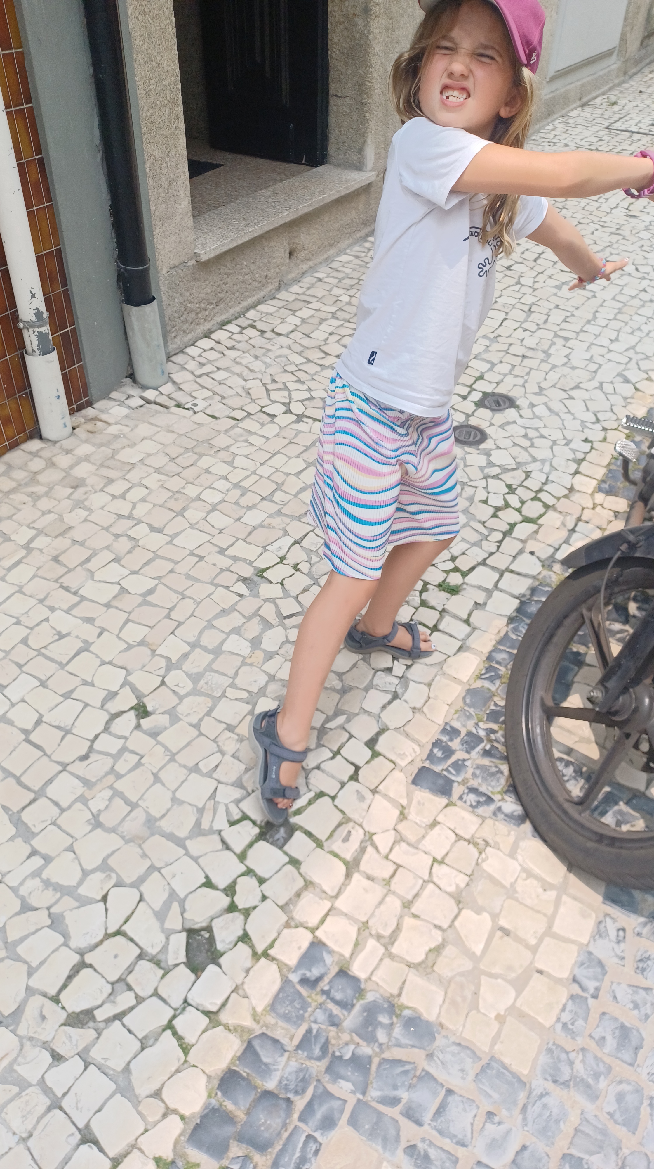 Child rolling ankle on cobblestone walkway